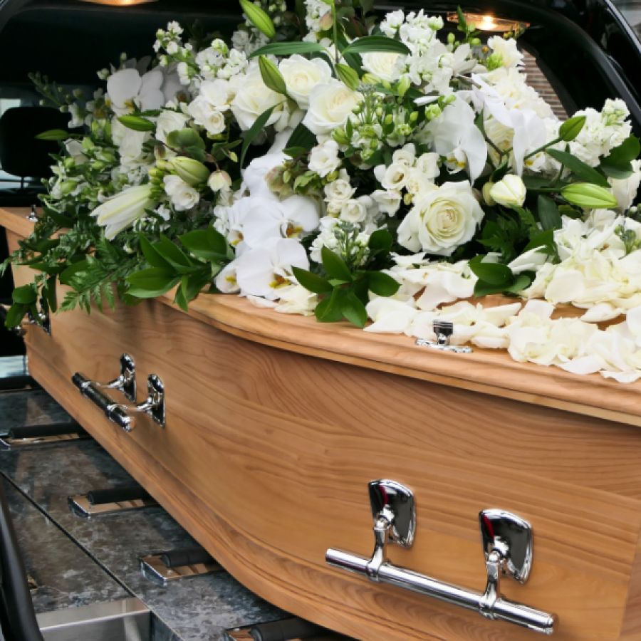 group of men carrying a coffin